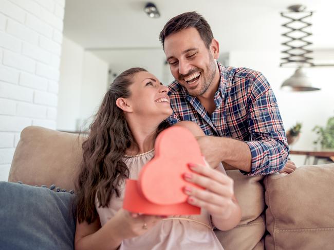 Young woman is happy and surprised with a gift from her husband.