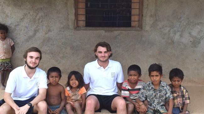 Adam Hegedus and Alexi Piovano from Educating the Future with children they hope to help in Timor-Leste. Picture: Supplied