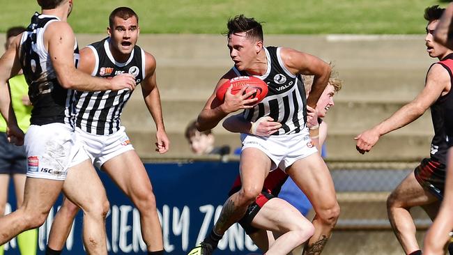 West's John Noble takes hold of Port's Aidyn Johnson. Picture: Tom Huntley