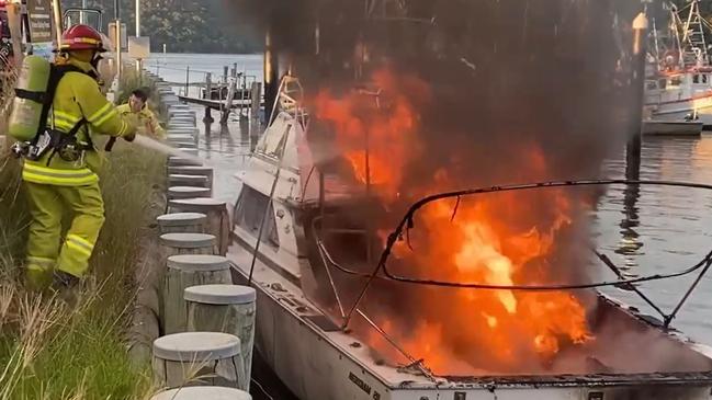 Fire crews battling the boat blaze. Picture: Greg Manning\