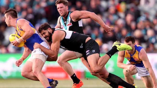 Elliot Yeo of the Eagles is tackled by Paddy Ryder of the Power during the round 21 match at Adelaide Oval. Picture: Getty Images