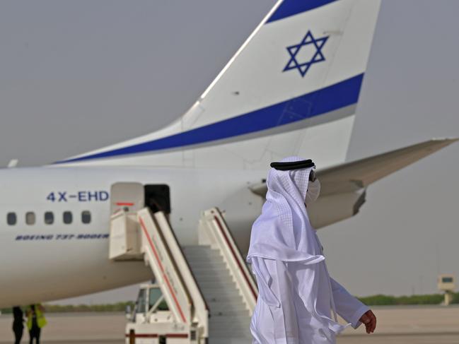 An Emirati official stands near an air-plane of El Al, which carried a US-Israeli delegation to the UAE. Picture: AFP