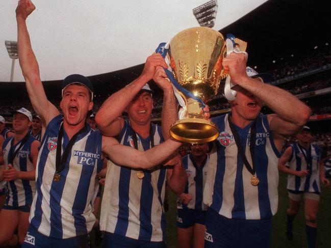 Laidley (left) celebrates North Melbourne’s 1996 Premiership win with teammates.