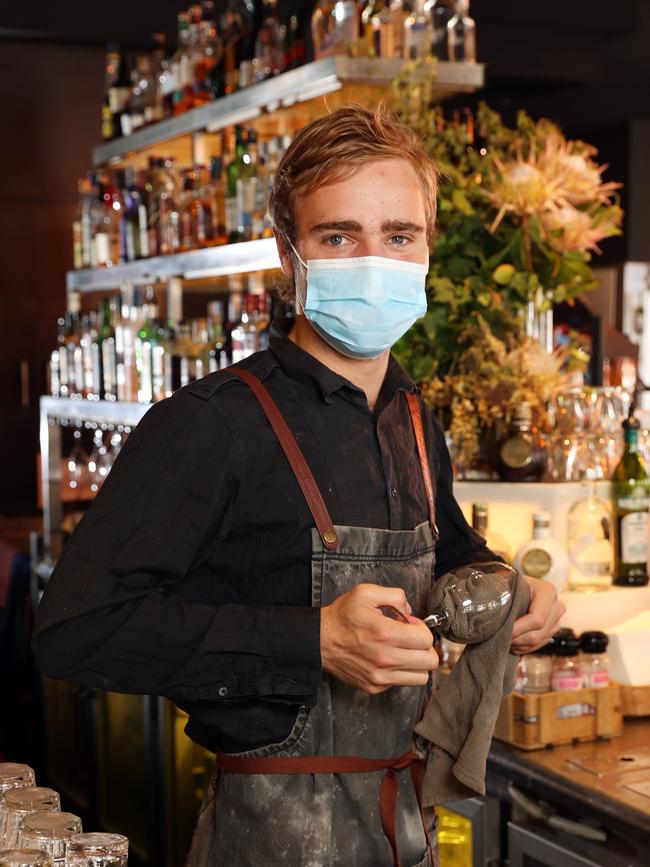 Mitchell Morri bartending during Covid. Picture: Richard Dobson