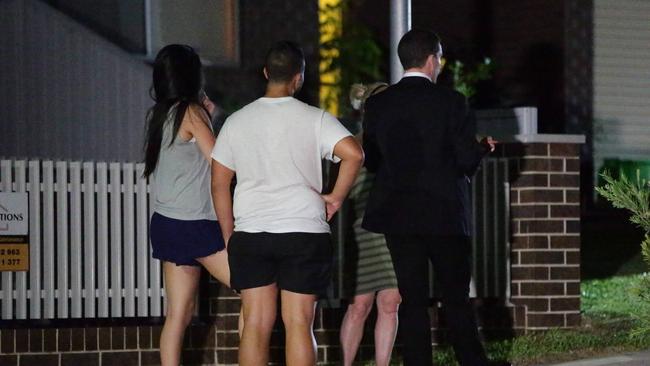 Neighbours speak with police outside the house. Picture: Bill Hearne