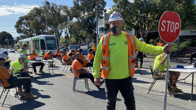 Construction workers block High St in Kew to protest the ban on using work site tea rooms. Picture: Manuela Cifra