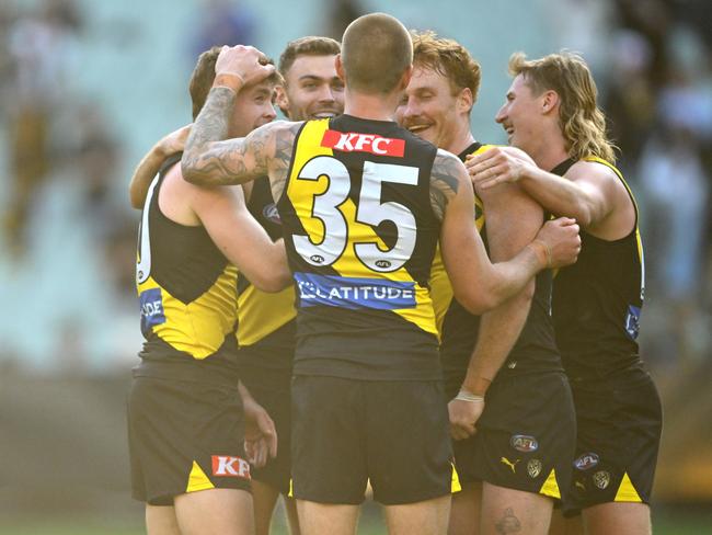 Tom Brown of the Tigers is congratulated by teammates after the final siren. Picture: Quinn Rooney/Getty Images.
