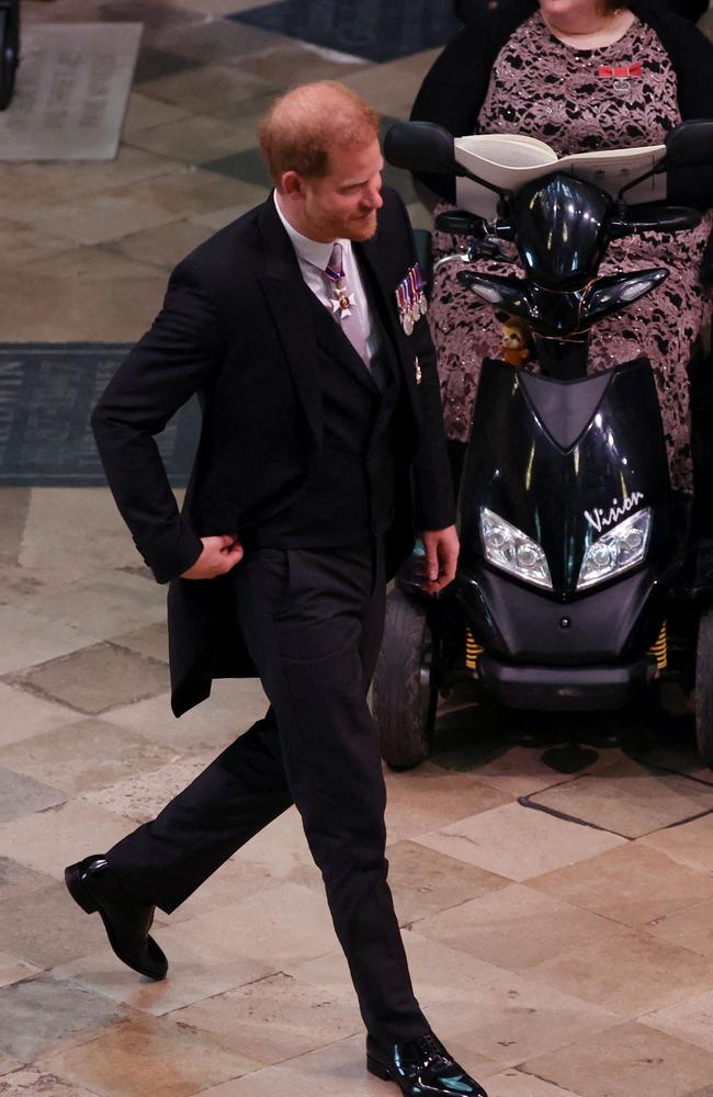 Prince Harry, Duke of Sussex wals solo as he finds his seat inside the abbey. Picture: Phil Noble/Pool/AFP
