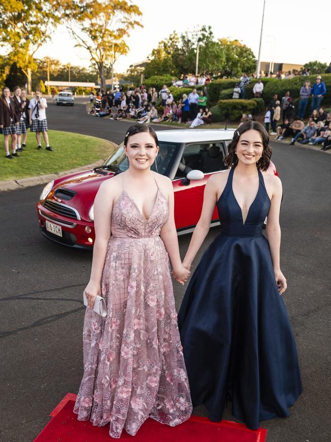 Chloe Krebs (left) and Lucia Hodges arrive at Harristown State High School formal at Highfields Cultural Centre, Friday, November 18, 2022. Picture: Kevin Farmer