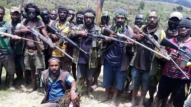 Tribal fighters in Papua New Guinea's Enga Province show their strength, armed with military-style rifles.