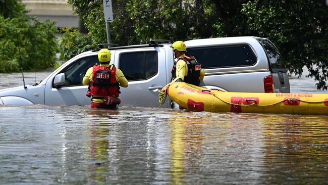 Swiftwater rescue crews checking a car inundated by floodwater at Hanlon Park at Stones Corner. Picture: Lyndon Mechielsen/Courier Mail