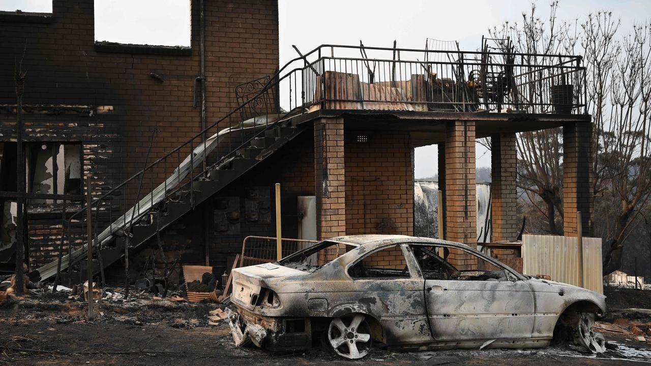 A house and vehicle gutted by bushfires in Lake Conjola in NSW. Picture: AFP