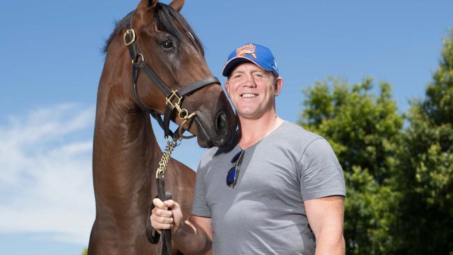 Tindall with a bay filly he has a stake in which is the first lot of the Magic Millions 2018 yearling sale. Picture: Luke Marsden.