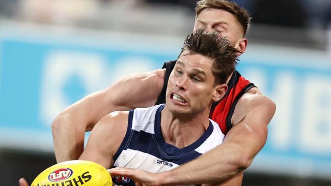 Jayden Laverde jostles with Geelong spearhead Tom Hawkins.