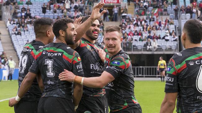 Greg Inglis celebrates with Rabbitohs teammates after scoring a try against the Dragons.