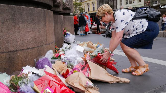 People pay their respects to the victims by laying flowers at Bourke Street Mall. Picture: Getty                        <a capiid="5ab79d7e419bbb39b217964cbef6ed09" class="capi-video">Four killed in Melbourne CBD attack</a>