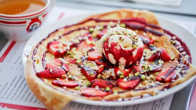 Crepe with fresh strawberries, crushed pistachios, berry coulis and white chocolate ice-cream.