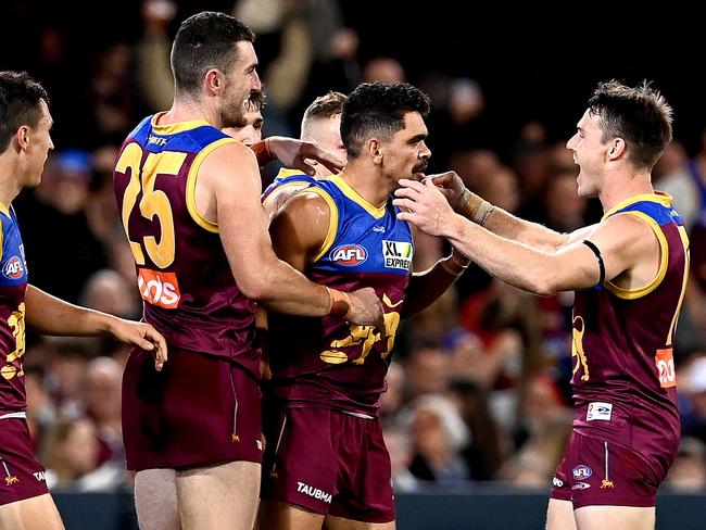 BRISBANE, AUSTRALIA - JUNE 24: Charlie Cameron of the Lions is congratulated by team mates after kicking a goal during the round 14 AFL match between the Brisbane Lions and the Geelong Cats at The Gabba on June 24, 2021 in Brisbane, Australia. (Photo by Bradley Kanaris/Getty Images)