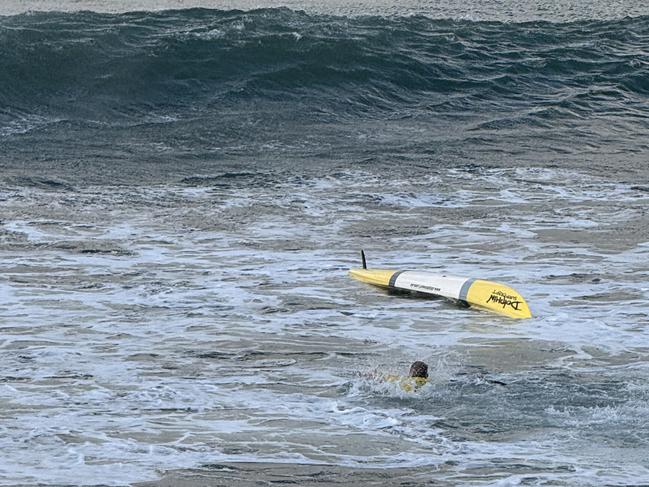 A man was flipped on his surfski before being helped by another ski rider, Grant Kenny, at Mooloolaba on Saturday morning.