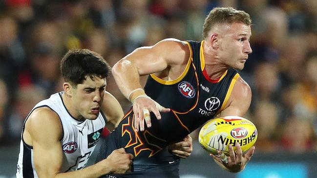 Rory Laird looks for an option. Picture: Sarah Reed/AFL Photos via Getty Images