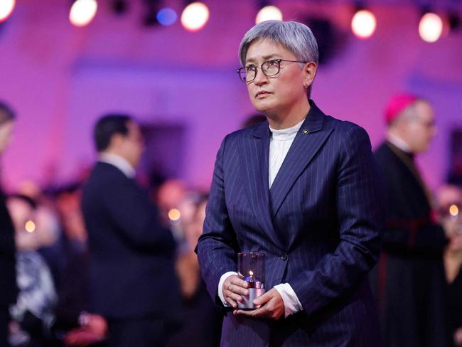 Australian Foreign Minister Penny Wong places a candle in front of the train car, the symbol of the event, to pay tribute to the victims during commemorations on the 80th anniversary of the liberation of the German Nazi concentration and extermination camp Auschwitz-Birkenau by the Red Army, in Oswiecim, Poland on January 27, 2025. (Photo by Wojtek RADWANSKI / AFP)