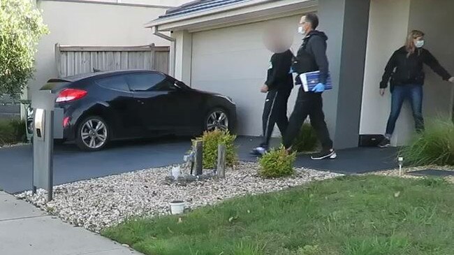 A man is arrested during the raids.