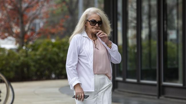 Sharon Ann Stott, 58, arrives at ACT Supreme Court during her trial over an alleged baseball bat stand over job.