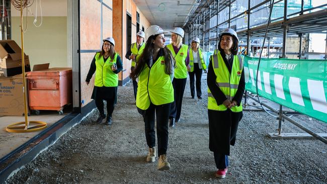 Education Minister Prue Car (right) inspects the construction site.