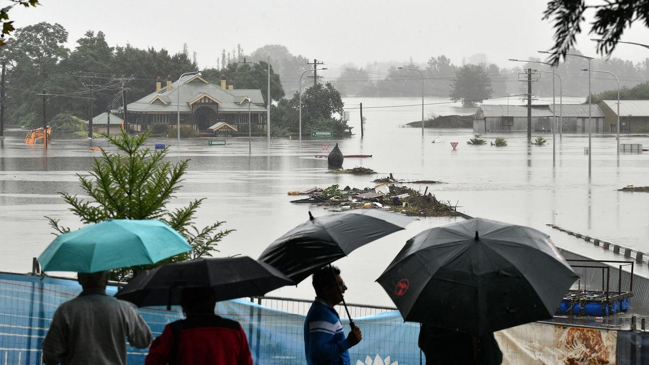 Residents look out at a flooded residential area in the Windsor area in northwestern Sydney. Picture: AFP