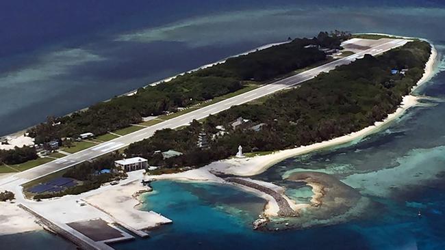 This handout picture taken and released on July 20, 2016 by the office of Kuomintang (KMT) lawmaker Johnny Chiang shows a general view of Taiping island in the South China Sea, before a group of lawmakers landed on the island onboard a military plane. Taiwanese lawmakers and fishermen headed to an island in the disputed South China Sea on July 20 to protest at an international tribunal ruling which undermined Taipei's claims there. Eight lawmakers from the ruling Democratic Progressive Party and the opposition Kuomintang (KMT) boarded a military plane to the Taiwan-controlled Taiping island in the Spratlys archipelago. / AFP PHOTO / The Office of Kuomintang (KMT) lawmaker Johnny Chiang / HO / --- EDITORS NOTE --- RESTRICTED TO EDITORIAL USE - MANDATORY CREDIT 
