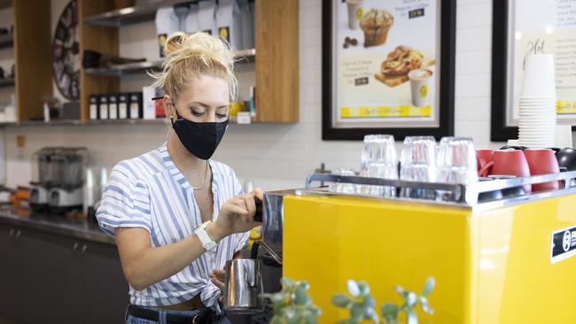 PERTH, AUSTRALIA - DECEMBER 24: A cafe worker wears a face mask on December 24, 2021 in Perth, Australia. The Western Australian government has implemented new COVID-19 restrictions, following the detection of a new community COVID-19 case. From 6pm on Thursday, masks will be mandatory in all public indoor settings in the Perth and Peel regions until December 28th. Authorities are also recommending people wear masks outdoors when physical distance can't be maintained. Large public events like music festivals have been cancelled during this period. (Photo by Matt Jelonek/Getty Images)