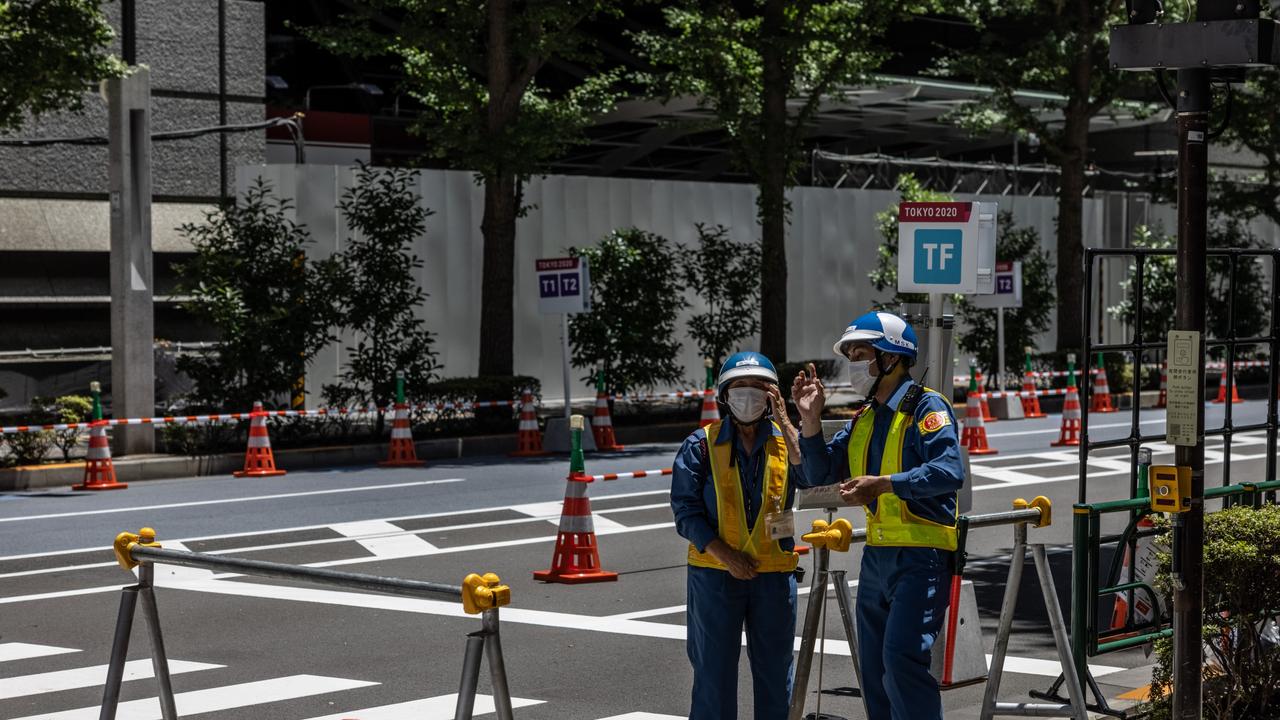 Security guards outside a blocked road next to Tokyo International Forum, the Olympics venue for weightlifting. Picture: Getty Images