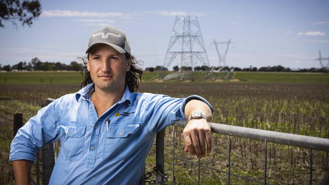 Uranquinty farmer James Petersen on his property with half-built transmission towers being built on his land. Picture: Ash Smith