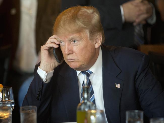 Mr Trump, pictured on his mobile during the US Presidential election, sparked controversy after speaking with the Taiwanese leader on Friday. Picture: Matt Rourke/AP
