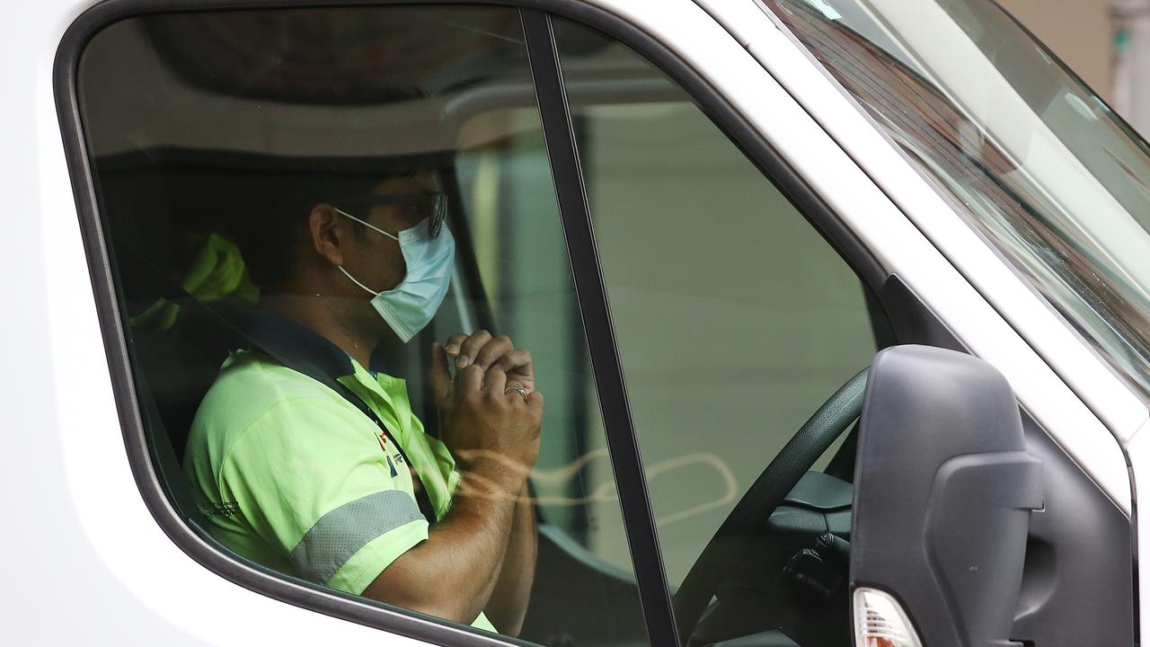 A driver wears a mask in his car on January 9. (Photo by Jono Searle/Getty Images)