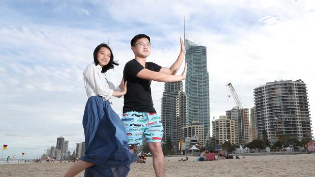 Chinese tourists are flocking to the Gold Coast in large numbers. Dongwan Wang (22) and Weihua Chen (23) having fun on Surfers Paradise beach. Picture by Scott Fletcher