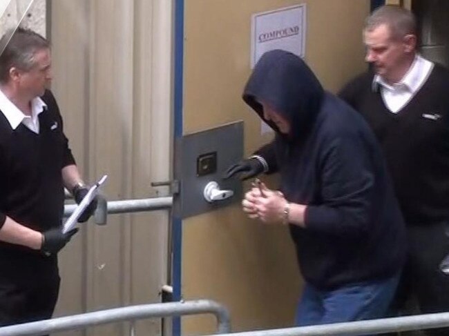 Kym Parsons is taken into court for his first appearance. Picture: 7NEWS