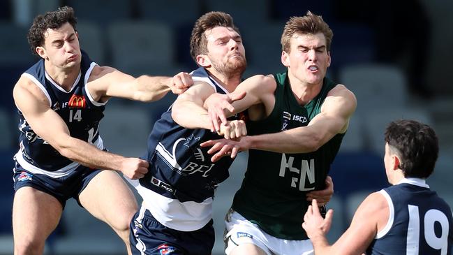 Ballarat’s Mitch Fino and Fraser Ampulski (from left) tries to spoil Hampden’s Mark Marriott. Picture Yuri Kouzmin