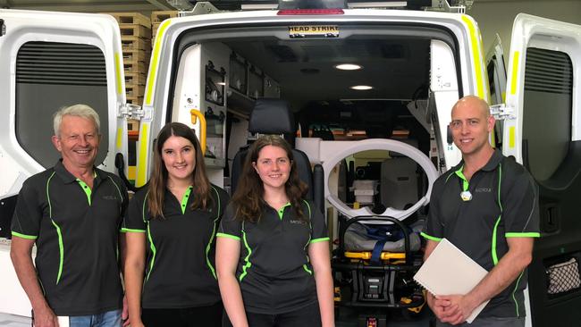 Micro-X managing director Peter Rowland, Flinders Uni biomedical engineering students Mia Maric and Erica Nunn that have worked on the scanner, and Micro-X engineering manager Anthony Skeats, working on prototype.