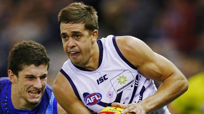 AFL Round 11: Western Bulldogs v Fremantle at Etihad Stadium. Stephen Hill gives Tom Liberatore the slip. Pic: Michael Klein. Saturday May 31, 2014.