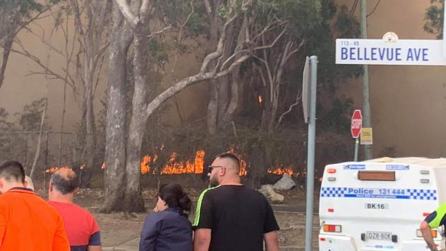 Residents watch the blaze at The Crest reserve, Georges Hall. Picture: Rachelle Harika