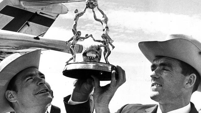 Ron Barassi and Neil Kerley hold the Harry Beitzel trophy for the international Gaelic football match in 1968.