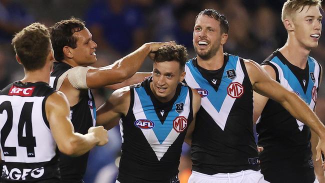 Orazio Fantasia is mobbed by his new teammates after kicking a goal. Picture: Michael Klein.