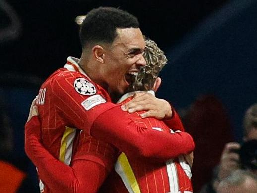 Liverpool's English forward #19 Harvey Elliott (CR) celebrates with Liverpool's English defender #66 Trent Alexander-Arnold (CL) after scoring Liverpool's first goal during the UEFA Champions League Round of 16 first leg football match between Paris Saint-Germain (FRA) and Liverpool (ENG) at the Parc des Princes stadium in Paris on March 5, 2025. (Photo by GEOFFROY VAN DER HASSELT / AFP)