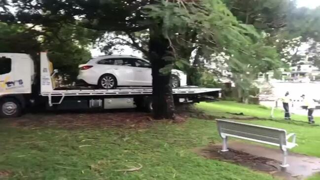 Trio flee after plunging car into water at Surfers