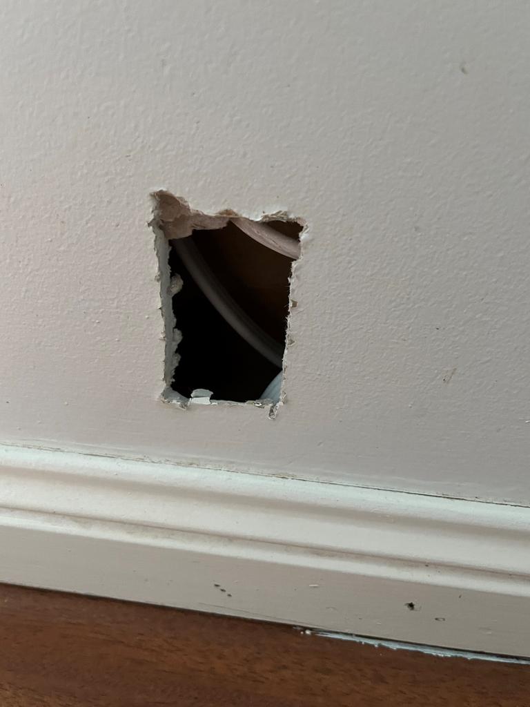 Holes have been left in the wall by electricians who haven’t returned. Picture: Supplied