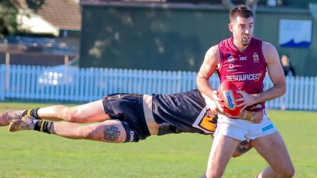 PAOC's Cam Giles is tackled during the win over Brighton. Picture: Brayden Goldspink