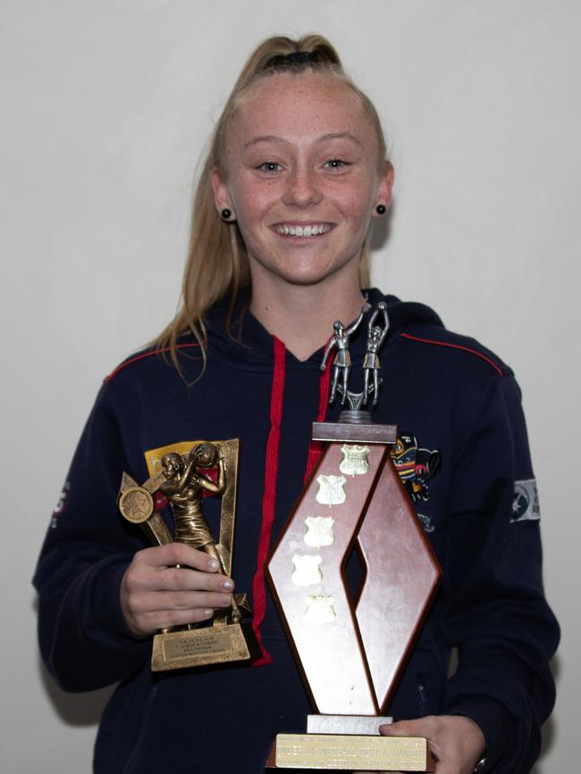 Meg with some of her netball trophies.