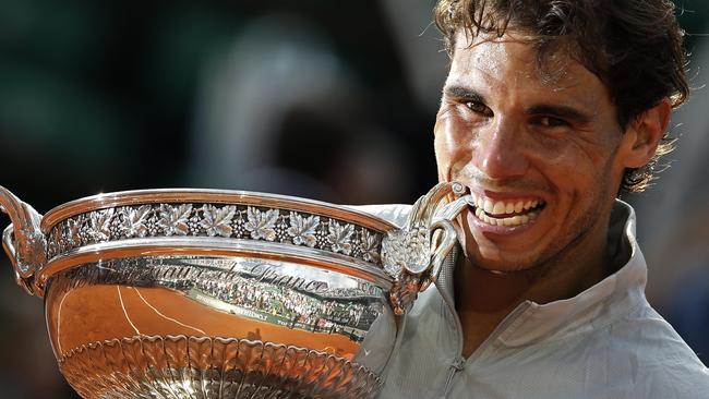 In this June 8, 2014, file photo, Rafael Nadal bites the trophy after winning the men's singles final of the French Open tennis tournament against Novak Djokovic.