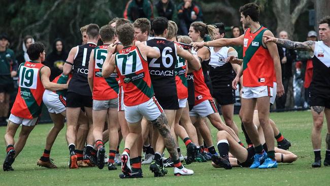 Players remonstrate after The Basin footballer Mitchell Rule is collected high in the Eastern Football League. Picture: Davis Harrigan